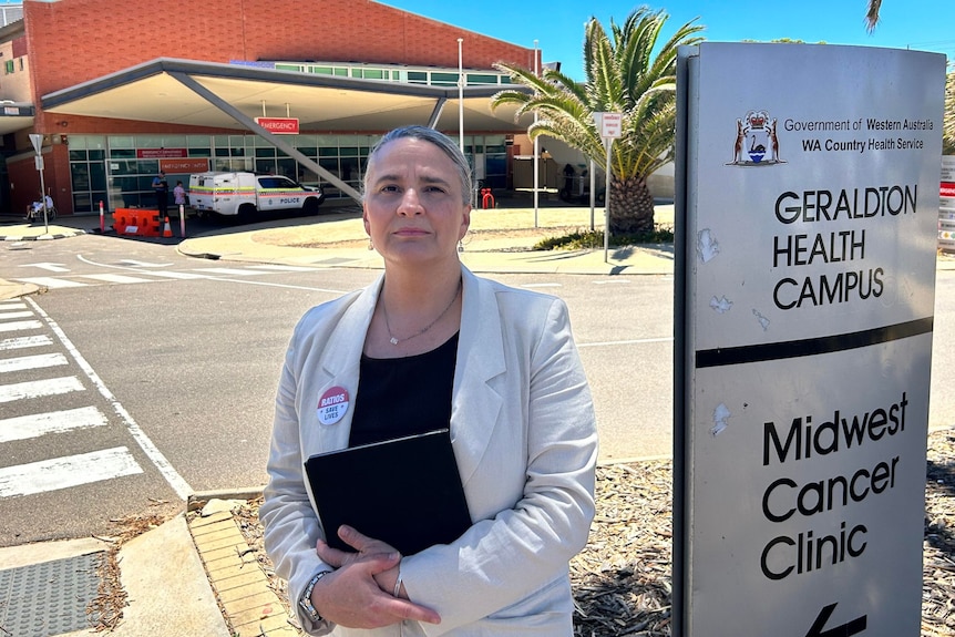Janet Reah holding a folder and standing outside the Geraldton Health Campus.