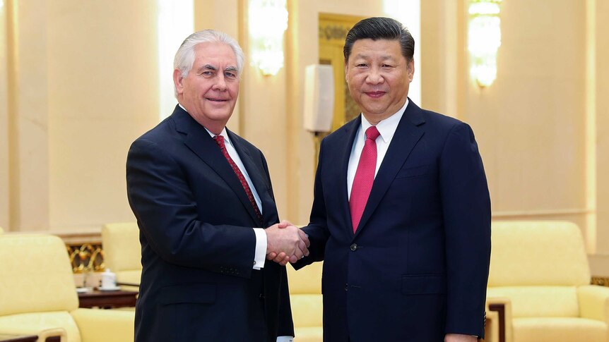 US Secretary of State Rex Tillerson shaking hands with Chinese President Xi Jinping