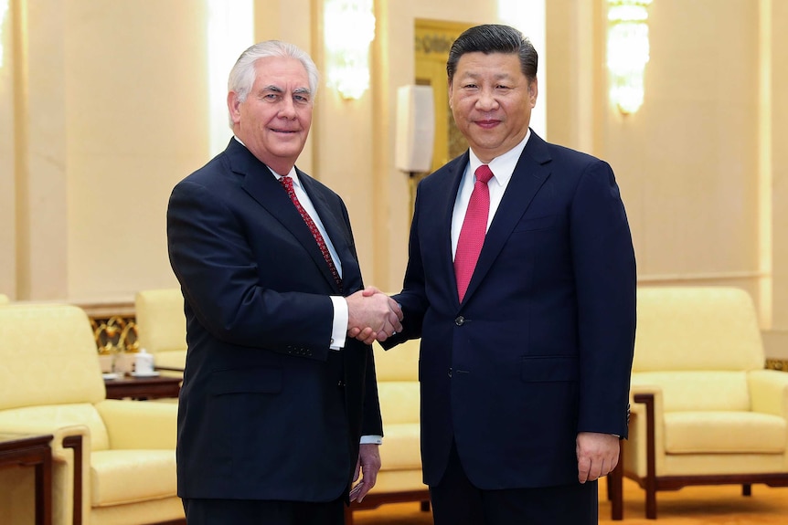 US Secretary of State Rex Tillerson shaking hands with Chinese President Xi Jinping