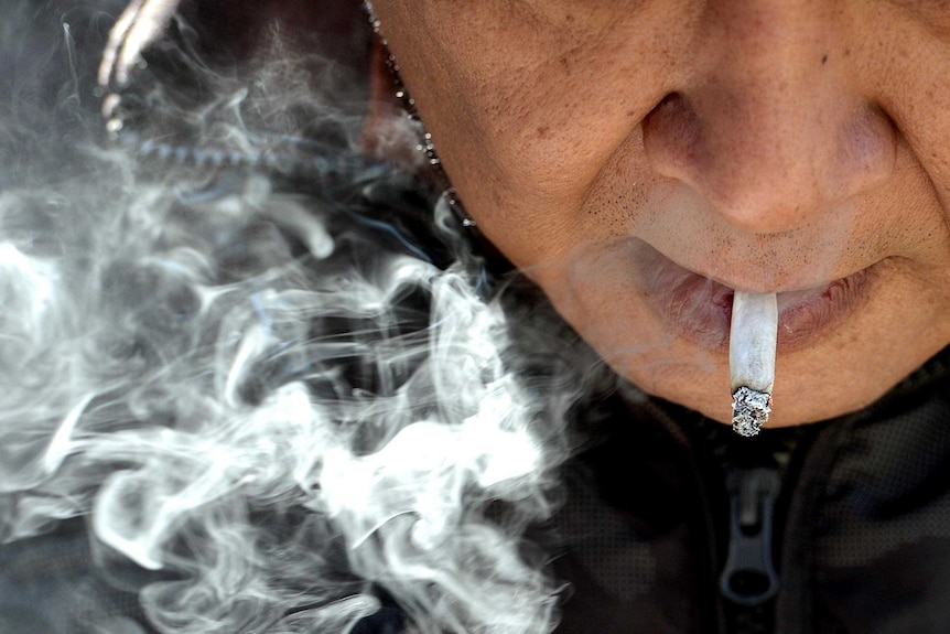 A man smokes a cigarette.