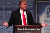 Donald Trump standing at a podium delivering an economic speech.