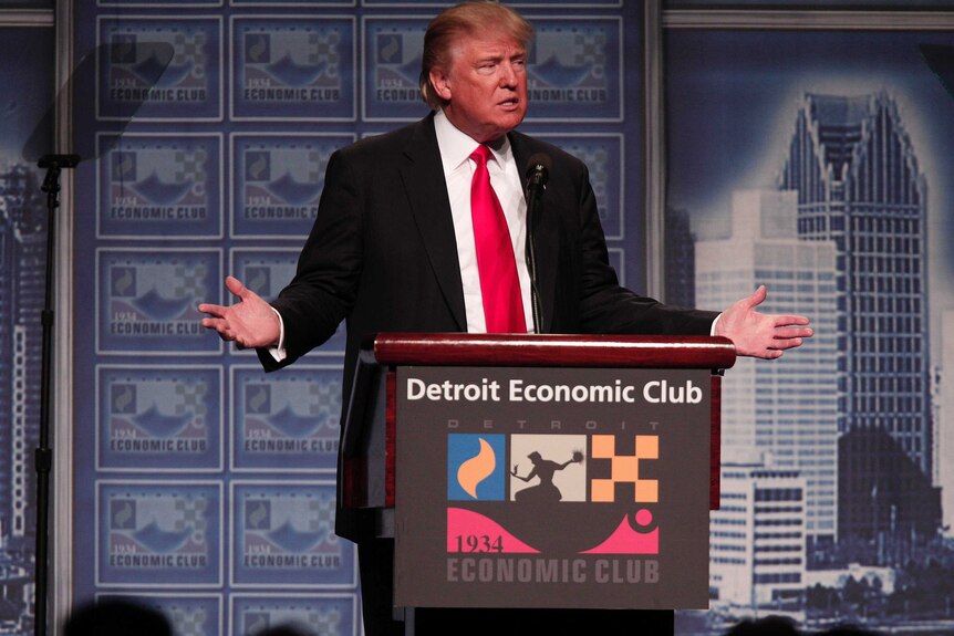 Donald Trump standing at a podium delivering an economic speech.