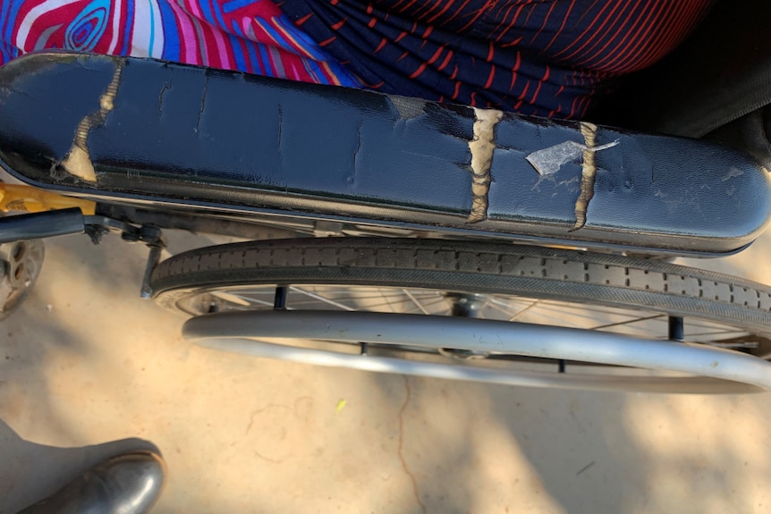An image of a wheelchair arm that is cracked and broken