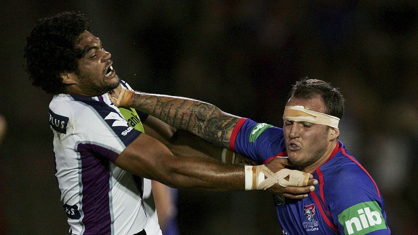 Corey Paterson of the Knights tries to shrug off Adam Blair.