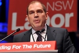 Jamie Clements speaks at a lectern.