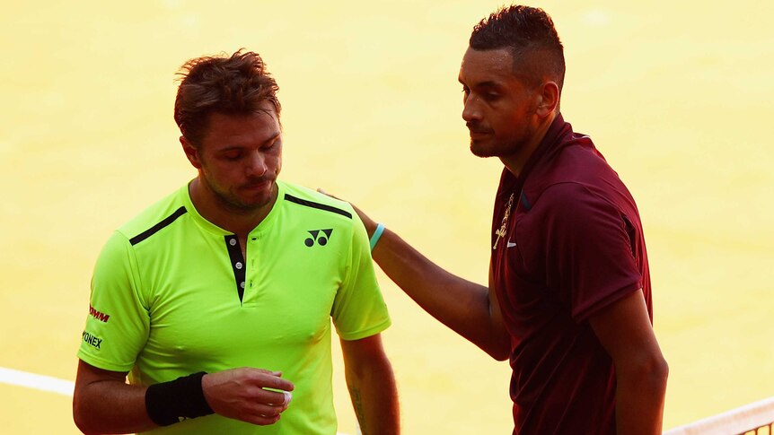 Australia's Nick Kyrgios (R) shakes hands with Stan Wawrinka after winning their Madrid Open match.