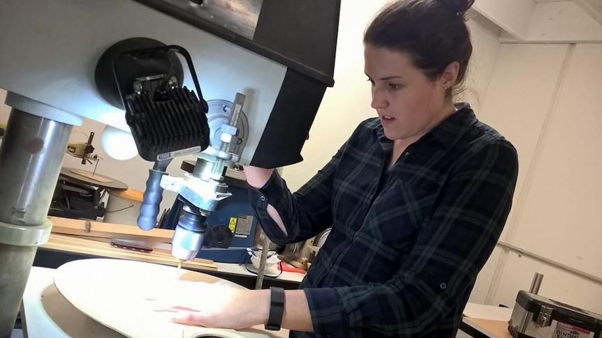 Workshop participants build the guitar from the ground up, including shaping the guitar body.