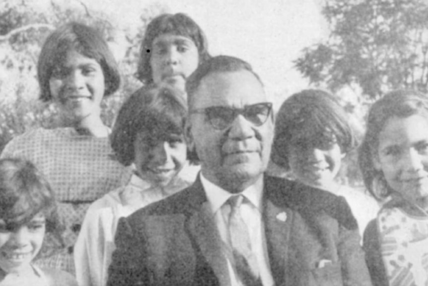 William Williams seated, surrounded by six young girls