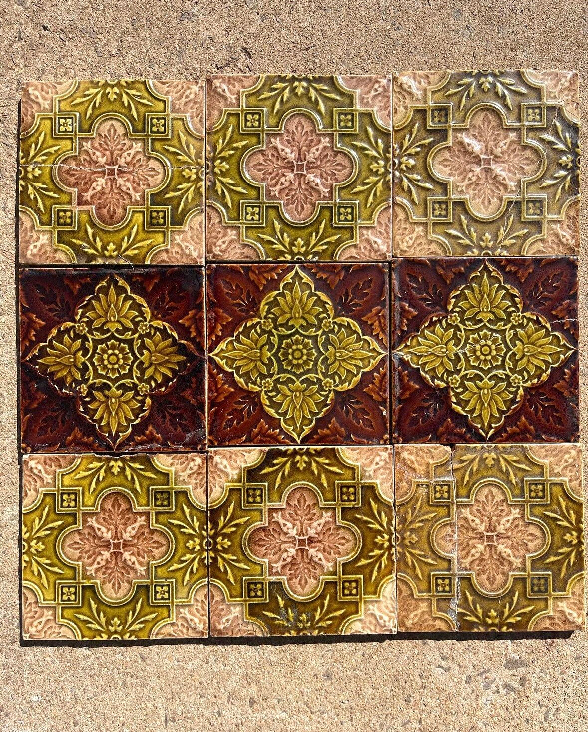 A set of deep-coloured glazed tiles with floral symbols