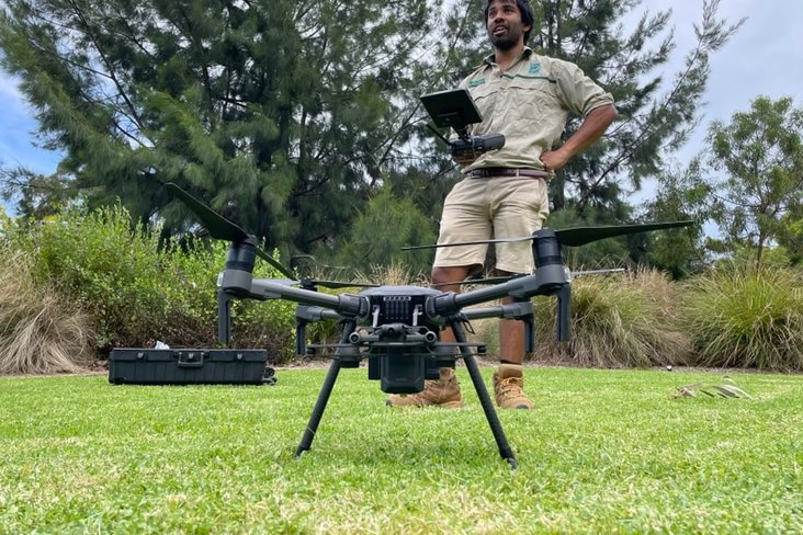 A drone sitting on a patch of grass.