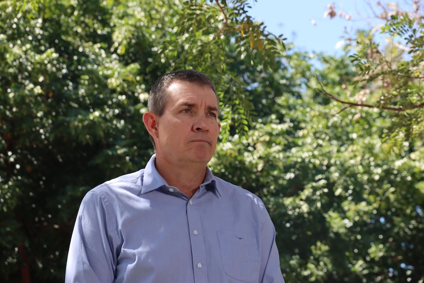CLP deputy leader Gerard Maley standing and looking serious outside on a sunny day, with greenery in the background.