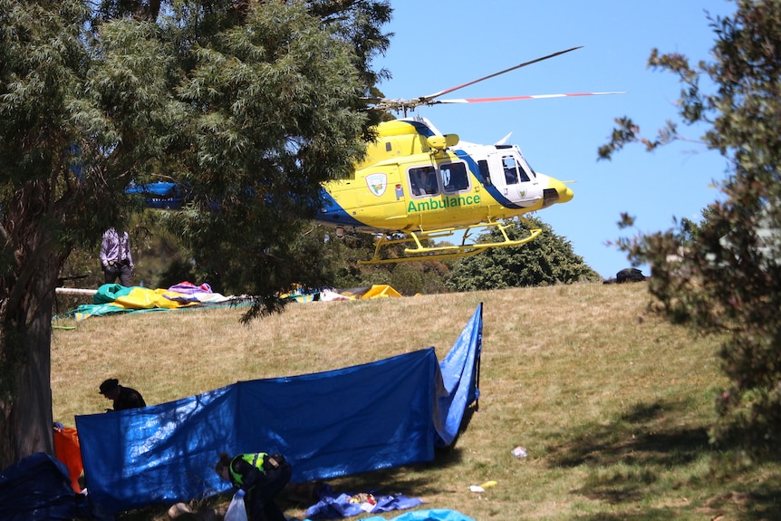 A helicopter takes flight from a field in Devonport.