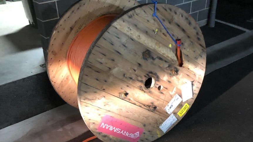 A giant wooden wheel of electrical cable