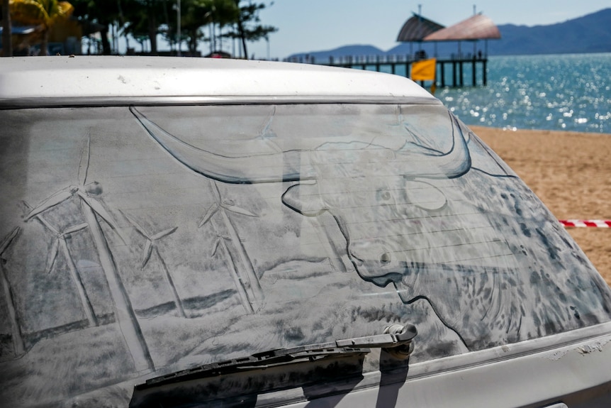 An image of a longhorn cattle created in the dust of a car rear window.