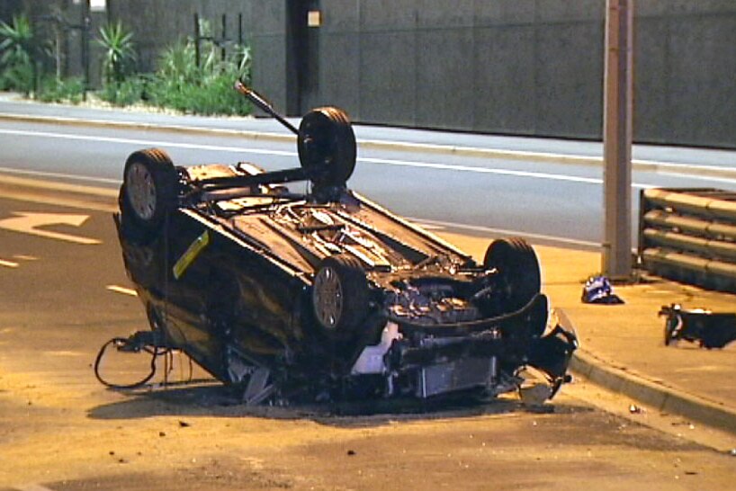 One of two cars severely damaged when the truck hit the bridge.