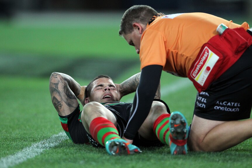 Down and out ... Adam Reynolds receives attention for his hamstring injury