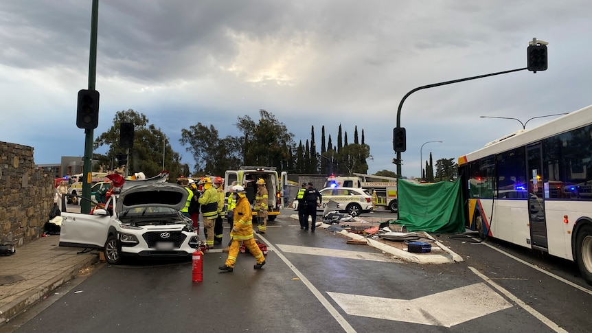 Emergency services at the scene of a serious crash that includes a white sedan