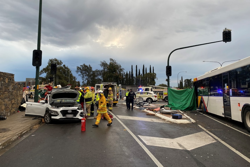 Emergency services at the scene of a serious crash that includes a white sedan