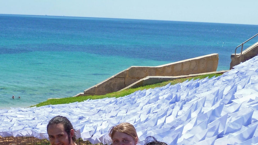 Sculpture work lifeboat with artists at Cottesloe Beach