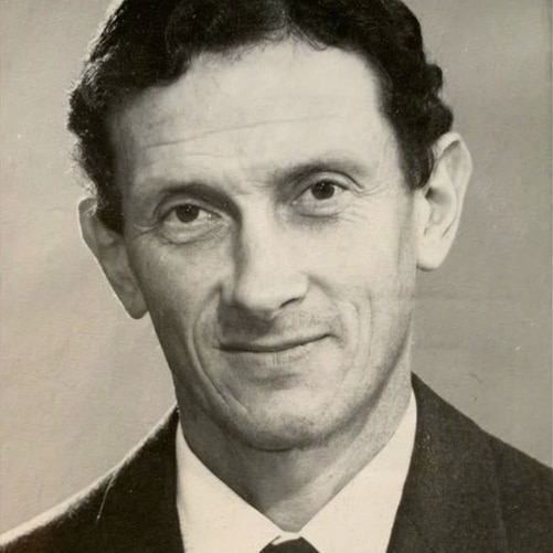 A close-up, black-and-white portrait of Alex Podolinsky.