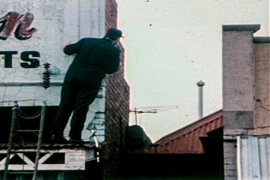 A policeman combs the area.