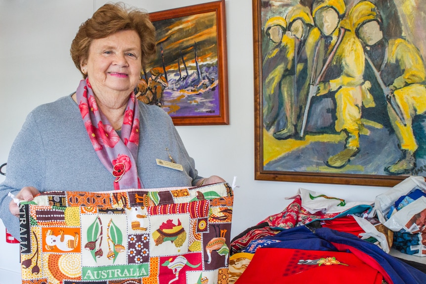 Lady holds laundry bag.