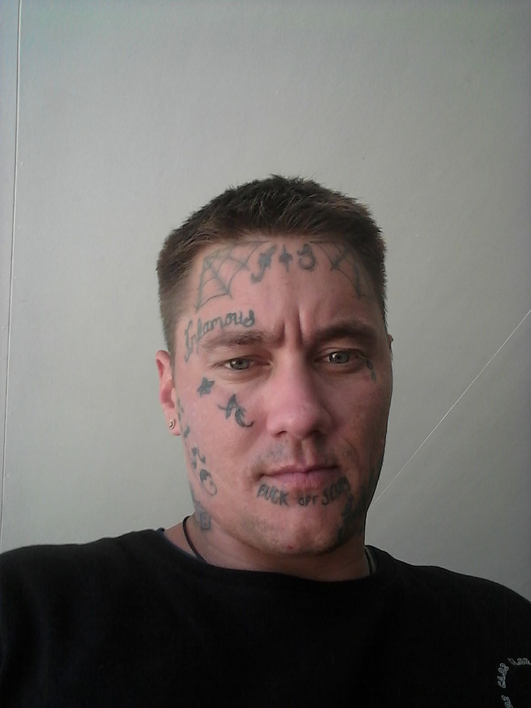 A man with face tattoos