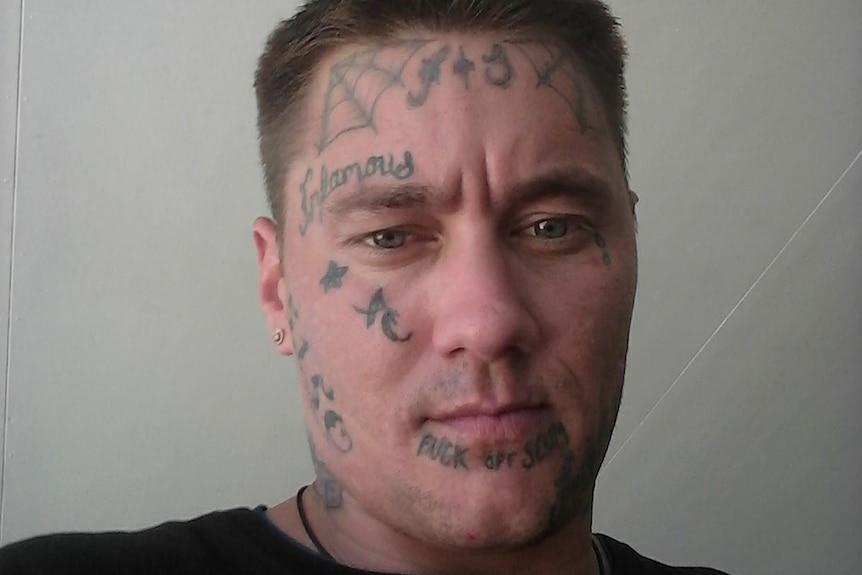 A man with face tattoos