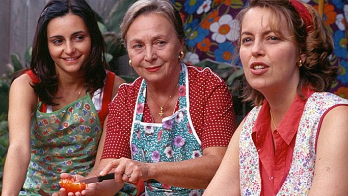 Three Italian Australian women sit close together - one older woman, one middle-aged, and the other a young woman