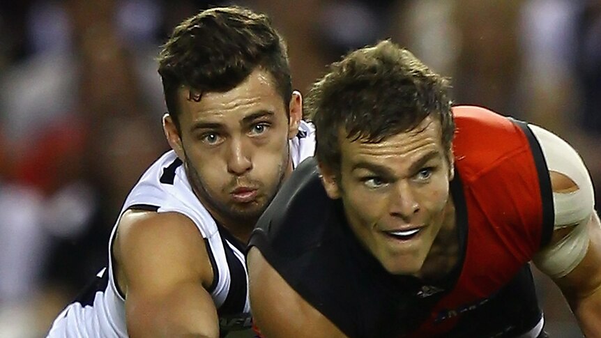Collingwood Magpies' Jarryd Blair tackles Brent Prismall of the Essingdon Bombers (Getty Images)