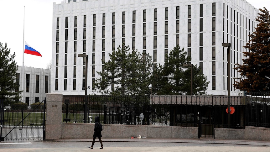 A pedestrian walks past the Russian Embassy in Washington, United States.