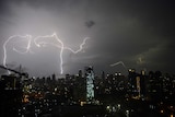 Lightning strikes over Jakarta's skyline during monsoon rains.