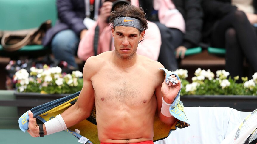 Taking a break ... Rafael Nadal towels down during a break between games