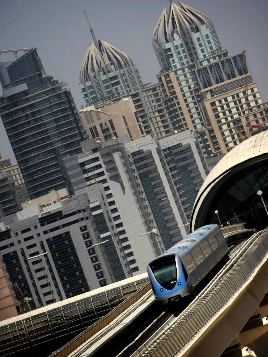 A metro train driving through Sheikh Zayed road in Dubai
