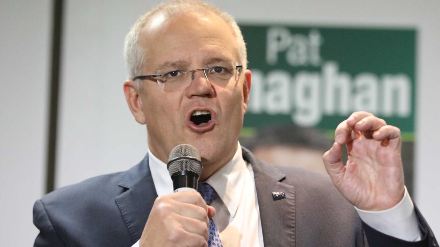 Morrison talks into the microphone
