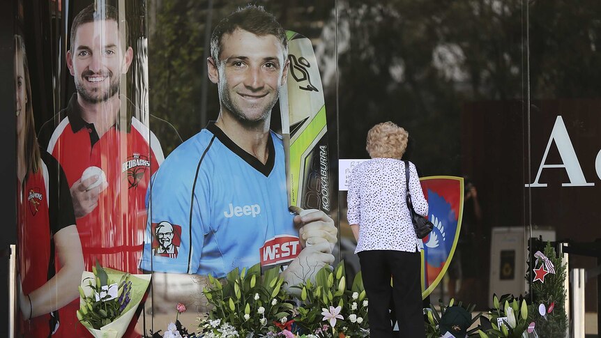 Flowers are placed beneath a photo of Phillip Hughes at Adelaide Oval.
