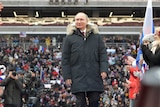 Vladimir Putin arrives to take part in a rally to support his bid in the upcoming presidential election.