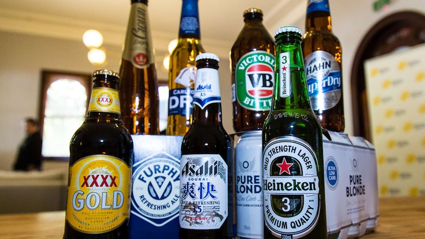 Various brands of beer bottles on display including low-carb beers.