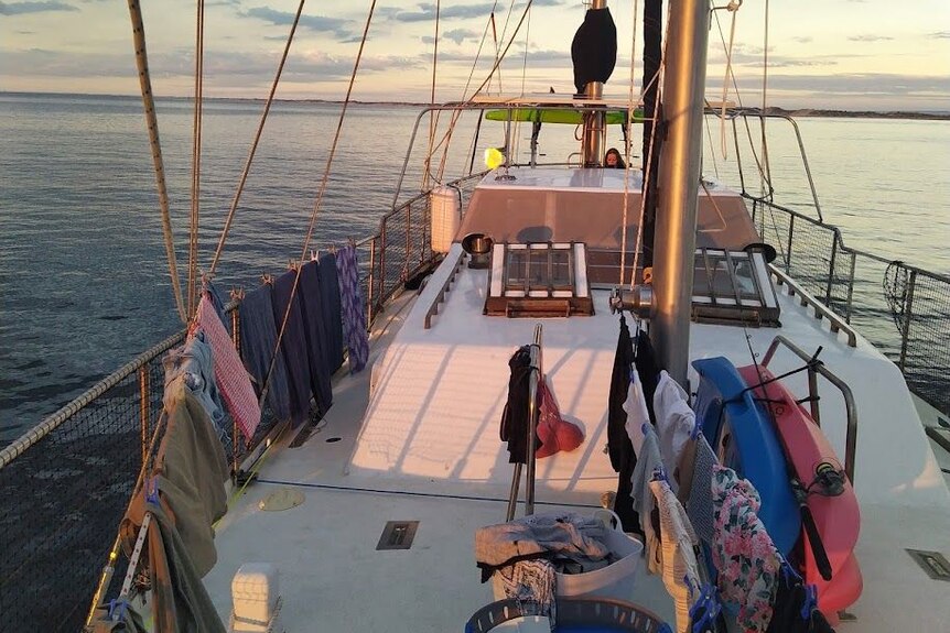 Laundry drying on the rails of a sailing boat.