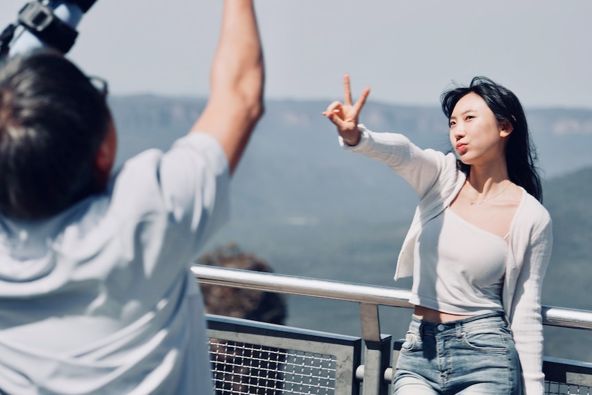 Chinese tourists posing to camera in the Blue Mountains.