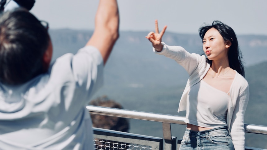 Chinese tourists posing to camera in the Blue Mountains.