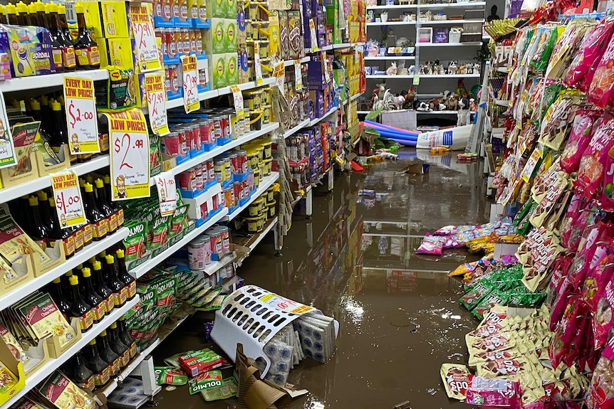 Flooded Wayne's World story in Laidley's main street with floodwater at the bottom of the store and goods on the shelves