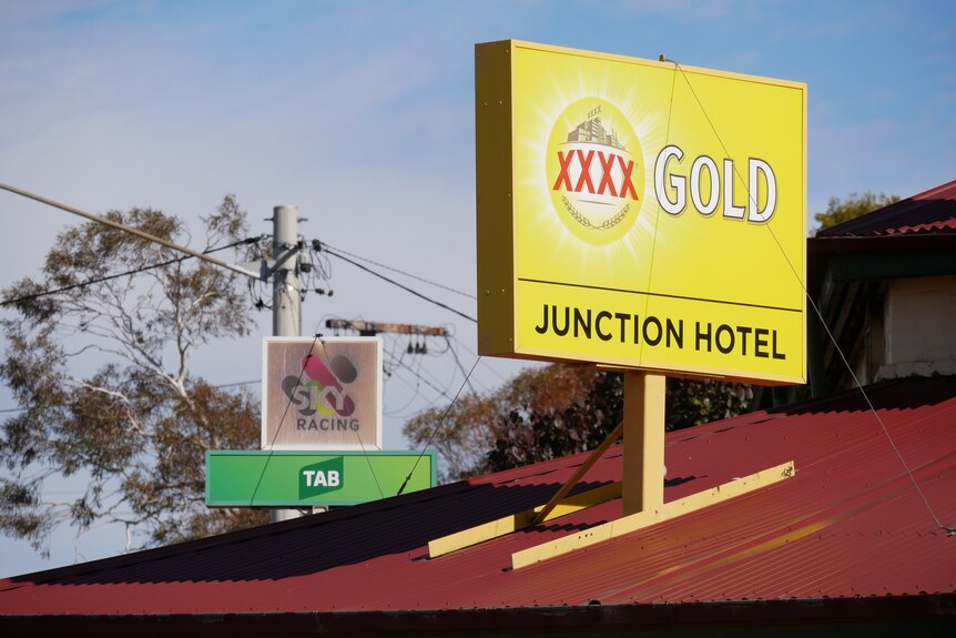a yellow sign on top of a red brick roof