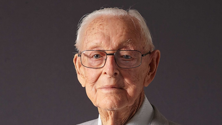Portrait image of an elderly man wearing war medals.