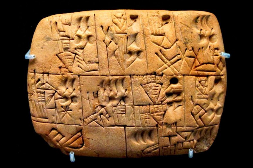 A rectangular clay tablet carved with cuneiform script.
