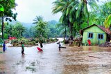Locals walk through floodwaters after days of heavy rain in the Solomon Islands.
