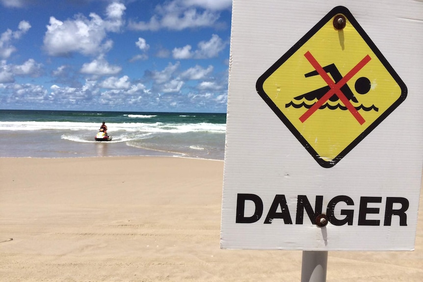 A lifesaver on a jet ski returns to the beach at Ballina on February 9, 2015