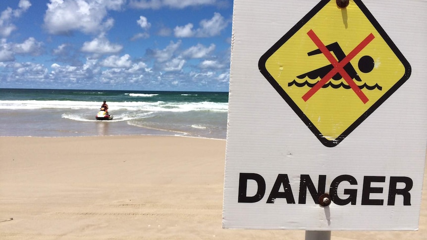 A lifesaver on a jet ski returns to the beach at Ballina on February 9, 2015