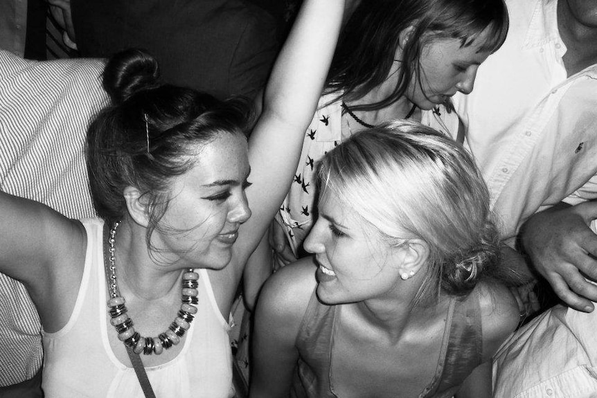 Black and white photo of Summer Land with her friend Emily dancing at an event.