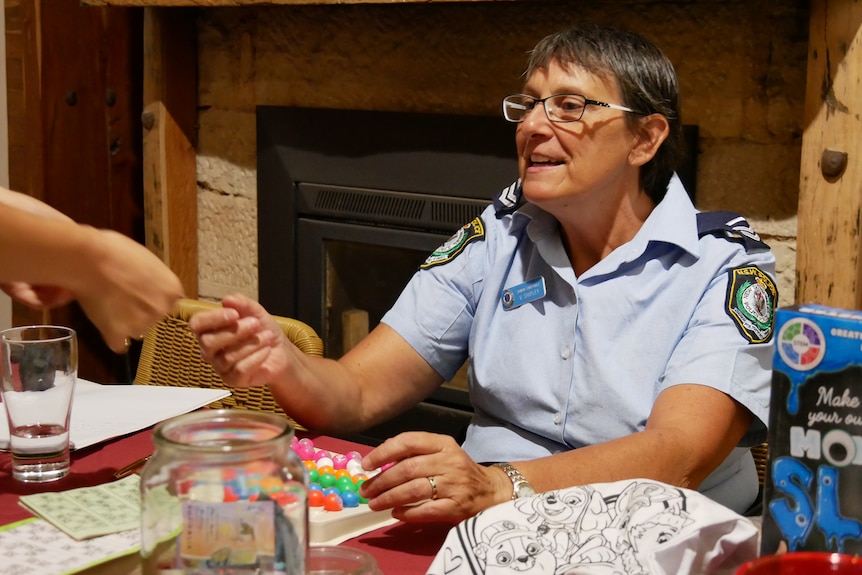 Senior Constable Vicki Shipley checking the numbers on a winning bingo card at the pub in Tibooburra